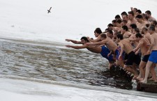 Bulgarian men jump into the waters of a lake to recover a wooden cross during the Epiphany day celebrations in Sofia.
