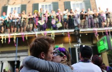 People celebrate Mardi Gras on Bourbon Street in the French Quarter of New Orleans