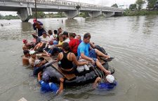 Honduran migrants cross the river that separates Guatemala and Mexico, Tecum Uman - 20 Oct 2018
